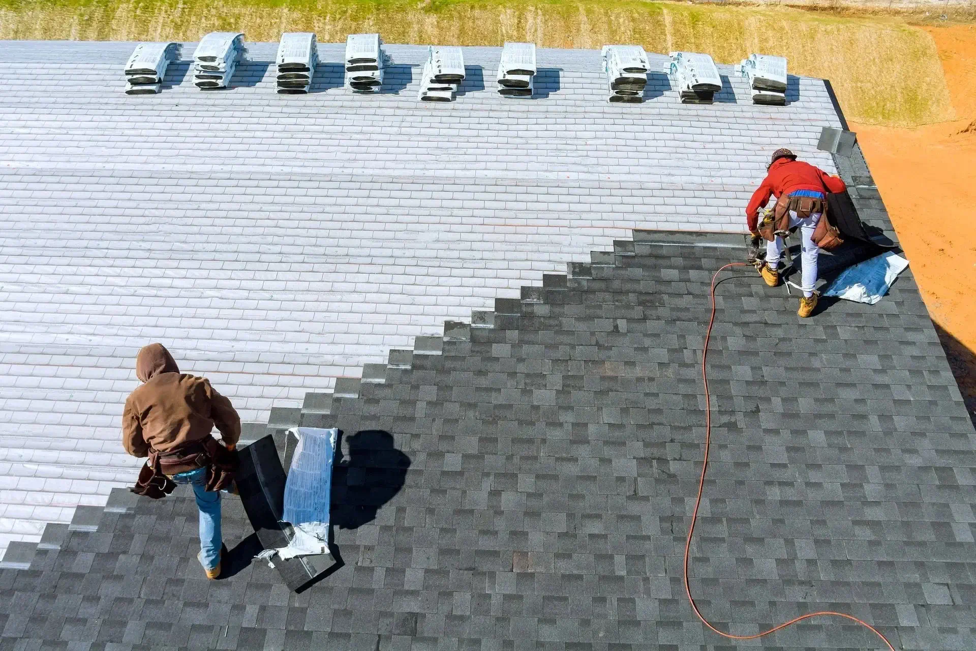 roofers repairing roof